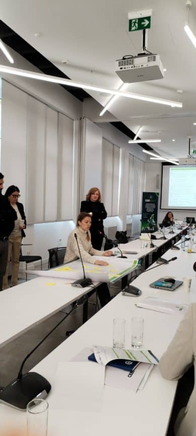 A group of people in a conference room AI-generated content may be incorrect.